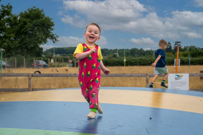 Boy on bouncy pillows in the summer