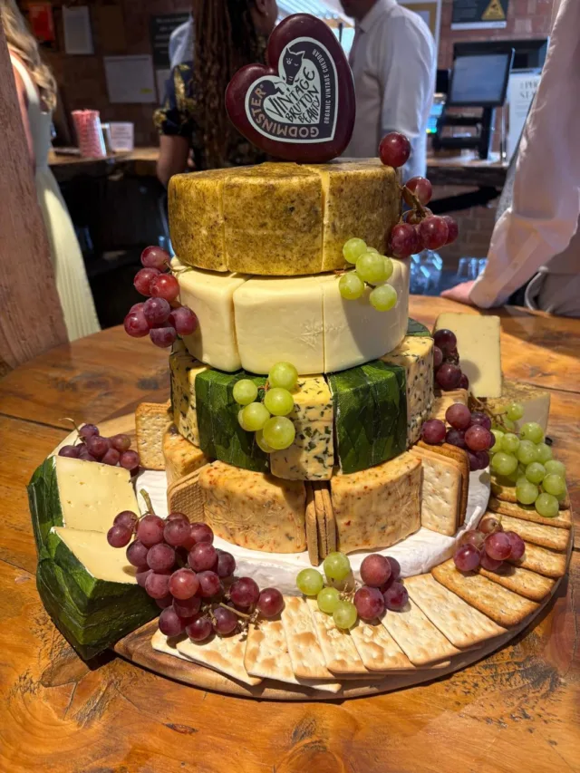 🧀 Cheese. Glorious cheese!

Who says your wedding cake has to be sweet?

This recent cheese cake was made using cheeses from the deli at our very own Farm Shop, finished with grapes and crackers for the ultimate evening spread.

And the best bit? Once the cake has had its moment, it can be taken apart and turned into a rather fabulous cheese board for your guests to enjoy.

A wedding cake that looks great, tastes even better and doesn’t go to waste? We’ll raise a cracker to that. 🥂🧀

Fancy creating your own? Head to the Farm Shop to explore our deli selection, or speak to the Over Barn team about your wedding catering.